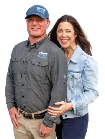 Portrait of a man in a Critter Gitters branded shirt and hat with a smiling woman.